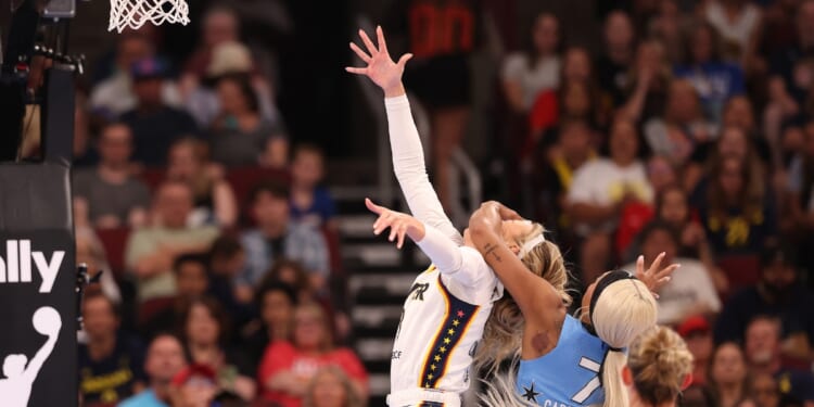 Sophie Cunningham of the Indiana Fever is fouled by DiJonai Carrington of the Chicago Sky during the first half at United Center on Aug. 8, 2026, in Chicago, Illinois.