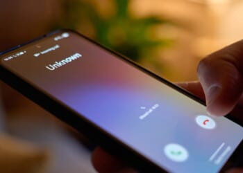 A phone screens displays an unknown caller.