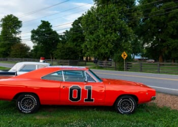 Replicas of the General Lee Charger and the Sheriff car, from the television series The Dukes of Hazzard, parked along a country road in the state of Tennessee on June 26, 2014.