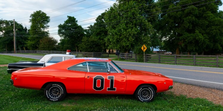 Replicas of the General Lee Charger and the Sheriff car, from the television series The Dukes of Hazzard, parked along a country road in the state of Tennessee on June 26, 2014.