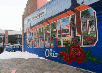 A vibrant mural on a brick wall reads “Greetings from Springfield, Ohio."