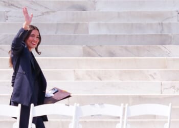 Rep. Alexandria Ocasio-Cortez waves as she arrives to speak during a "Defend the Vote" rally at the Lincoln Memorial in Washington, D.C., on Aug. 28, 2026.