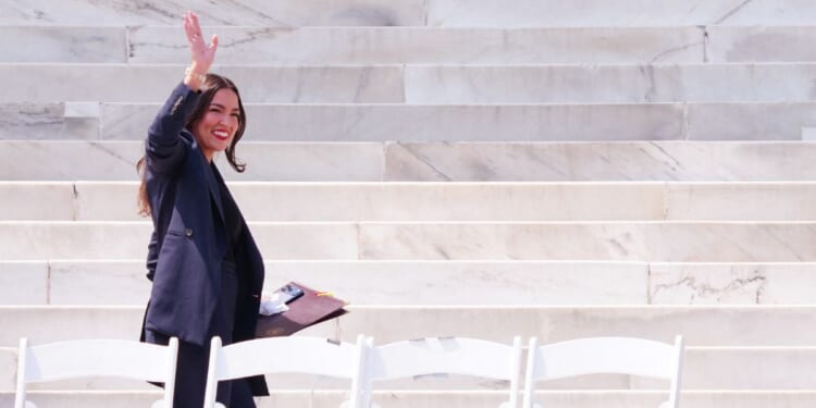 Rep. Alexandria Ocasio-Cortez waves as she arrives to speak during a "Defend the Vote" rally at the Lincoln Memorial in Washington, D.C., on Aug. 28, 2026.