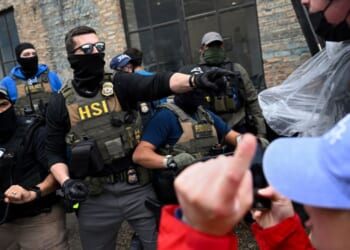 Agents from Immigration and Custom's Enforcement (ICE) clash with angry agitators in Chicago on June 4, 2025.