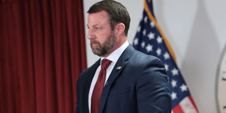 Secretary of Homeland Security Markwayne Mullin stands silently during a press conference at the U.S. Citizenship and Immigration Services New York field office on Sept. 1, 2026, in New York City.