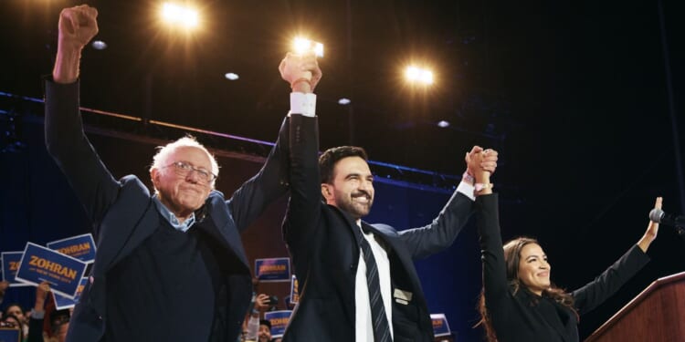 New York Mayor Zohran Mamdani celebrates with Sen. Bernie Sanders and Rep. Alexandria Ocasio-Cortez during an election rally on Oct. 26, 2025, at Forest Hills Stadium in the Queens borough of New York City.