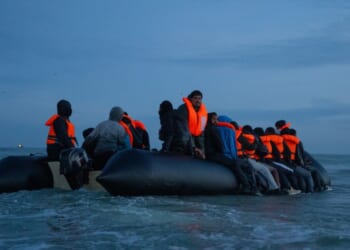 Migrants sit aboard a dinghy as they prepare to sail into the English Channel on Sept. 21, 2026, in Gravelines, France.