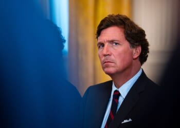 Tucker Carlson looks on in the East Room of the White House on Jan. 9, 2026 in Washington.