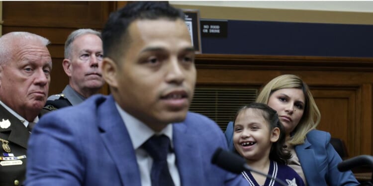 Marcus Coleman, father of Dalilah Coleman, seen sitting behind him, who was permanently disabled after an illegal alien caused a multi-car crash, testifies as his wife Ileana Krause, right, listens during a hearing before the Subcommittee on Immigration Integrity, Security, and Enforcement of the House Judiciary Committee Tuesday in Washington, D.C.