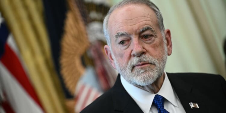 U.S. Ambassador to Israel Mike Huckabee listens during a meeting with President Donald Trump at the White House in Washington, D.C., on April 23, 2026.