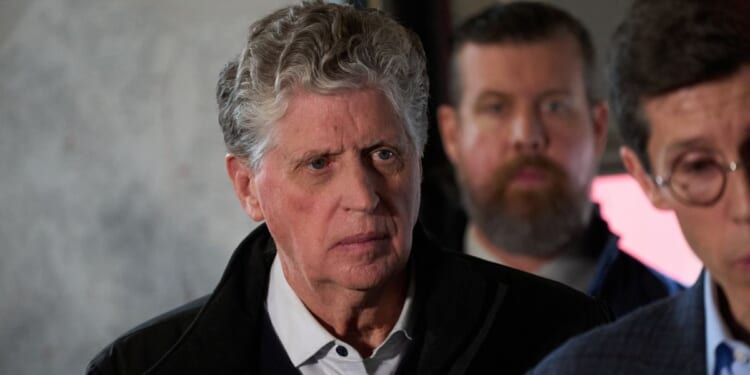Rhode Island Gov. Daniel McKee looks on during a press conference near the campus of Brown University in Providence, Rhode Island, on Dec. 14, 2025.