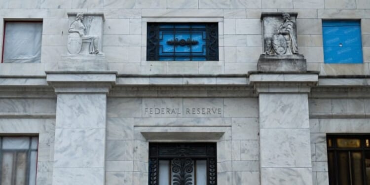 The Federal Reserve building stands in Washington, D.C. under gray skies.