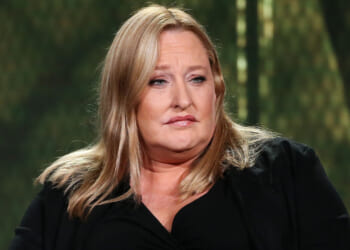 Heidi Beirich, former intelligence project director at the Southern Poverty Law Center, moved to continue her case with the SPLC. Pictured: a woman with long blonde hair, wearing a black top, sits in front of a blurred green background, looking slightly to the side with a neutral expression.