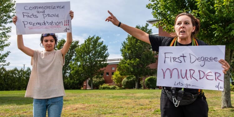 Demonstrators call for a first-degree murder verdict Tuesday as they protest outside the courthouse during the jury deliberation phase of Lindsay Clancy's murder trial at the Plymouth County Superior Court in Plymouth, Massachusetts.