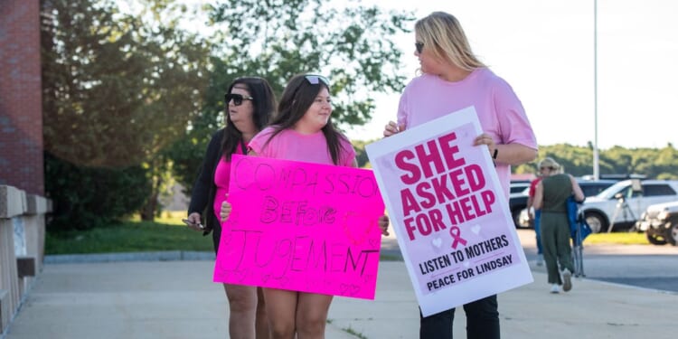 Supporters of Lindsay Clancy hold signs outside the Plymouth County Superior Court during Lindsay Clancy's murder trial in Plymouth, Massachusetts, on Aug. 26, 2026.