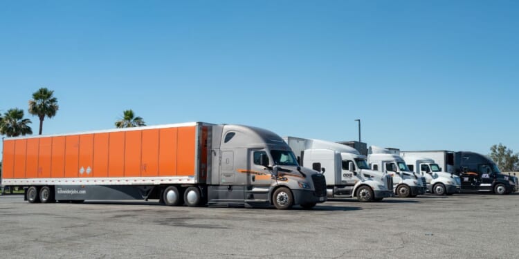 Truckers with semitrucks park in a rest area in Buttonwillow, California, on June 26, 2026.