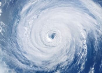 A hurricane is pictured as winds and clouds circle around the eye of the storm.