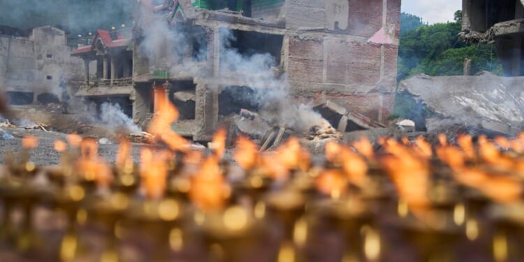 Nepal holds a day of mourning after floods kill at least 1,300 people