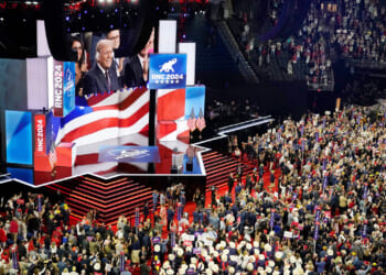 A large crowd fills an arena with a stage displaying RNC 2024 and American flags. A speaker addresses the audience, while people hold signs and cheer. The atmosphere is lively and patriotic.