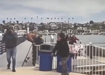 Unidentified individuals climb off of a panga that landed in Newport Beach, California.