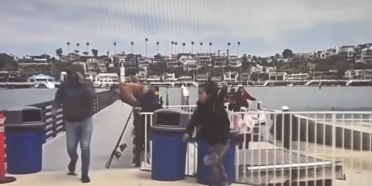 Unidentified individuals climb off of a panga that landed in Newport Beach, California.