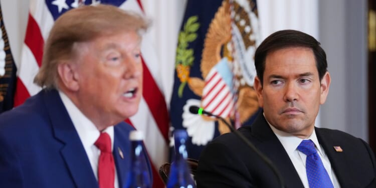 Secretary of State Marco Rubio listens as President Donald Trump speaks during a roundtable on the American mining industry at the Department of State on Aug. 7, 2026, in Washington, D.C.