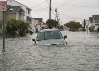 A car is seen submerged in water on a flooded road in Point Pleasant, New Jersey, on Sept. 26, 2026.