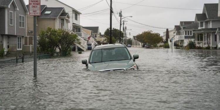 A car is seen submerged in water on a flooded road in Point Pleasant, New Jersey, on Sept. 26, 2026.