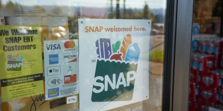 A "SNAP Welcomed Here" sign is seen at the entrance to a Big Lots store in Portland, Oregon, on Oct. 28, 2020.