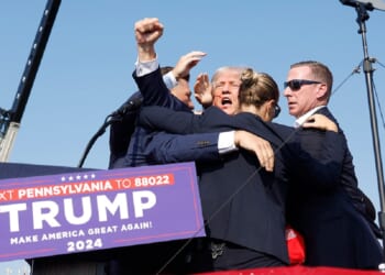 Then-candidate Donald Trump is surrounded by Secret Service agents after being wounded in a July 2024 assassination attempt in Butler, Pennsylvania.