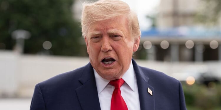 President Donald Trump, seen in a Saturday photo, called the Axios story a "hoax" and urged the political news outlet to retract it.