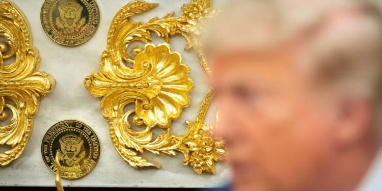 Trump casts his presidential legacy in gold and marble