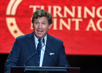 Political commentator Tucker Carlson speaks during the memorial service for political activist Charlie Kirk at State Farm Stadium on Sept. 21, 2025, in Glendale, Arizona.