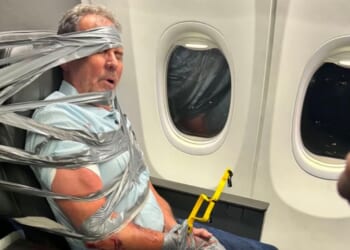 A man was duct taped to an airplane seat in a moment that went viral online.