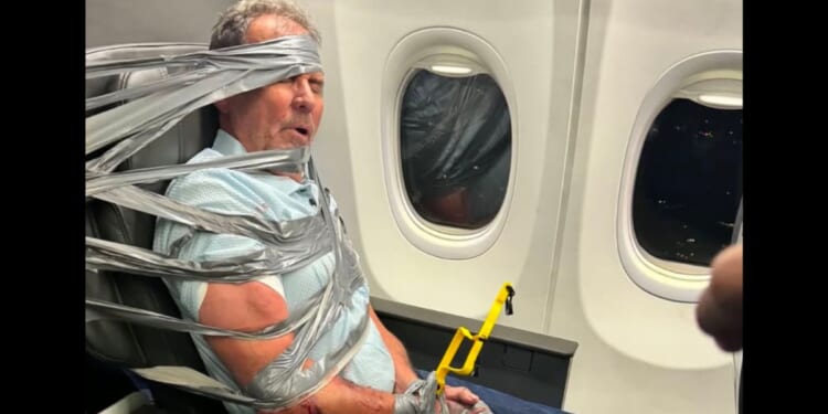 A man was duct taped to an airplane seat in a moment that went viral online.