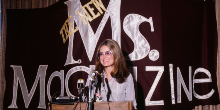 Feminist author Gloria Steinem speaks from a podium at a 1985 news conference about Ms magazine, which she cofounded.