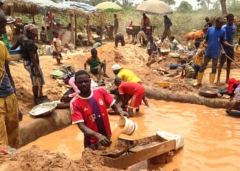 In this photograph taken on April 4, 2018, gold miners work at a mining site in the Cameroon town of Betare Oya.