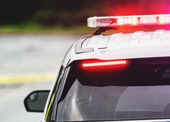 Police block a road at the scene of an emergency.