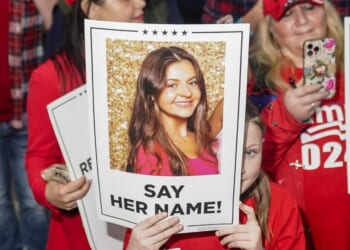Supporters of President Donald Trump hold up pictures of Laken Riley on March 9, 2024 in Rome, Georgia, after she was murdered by an illegal immigrant.