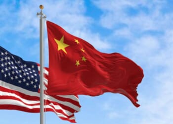 The Chinese flag flies next to an American flag.