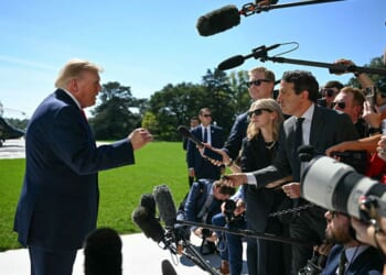 President Donald Trump talks to members of the media before boarding Marine One from the South Lawn of the White House in Washington, D.C., on Oct. 1.
