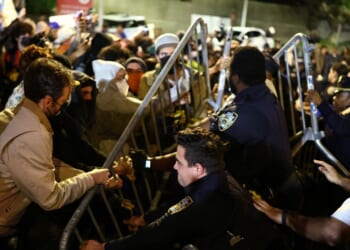 Protesters and law enforcement officers clash close to the scene where a man was shot by an Immigration and Customs Enforcement officer during an operation in the Bronx borough of New York on Oct. 8, 2026, according to local media and police.