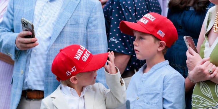 Guests donning Make America Great Again hats wait to greet President Donald Trump at the congressional picnic on the South Lawn of the White House on May 19, 2026, in Washington, D.C.
