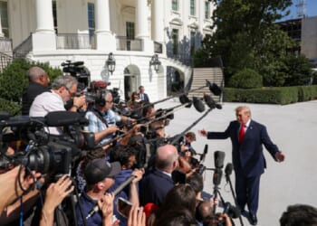 President Donald Trump deals with a horde of reporters outside the White House Oct. 1.