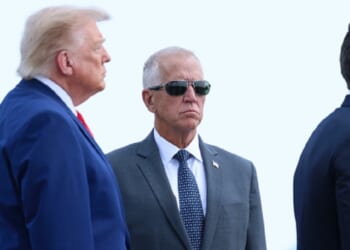 President Donald Trump and Sen. Thom Tillis are pictured in a July file photo from a ceremony marking the return of slain U.S. soldiers to American soil.