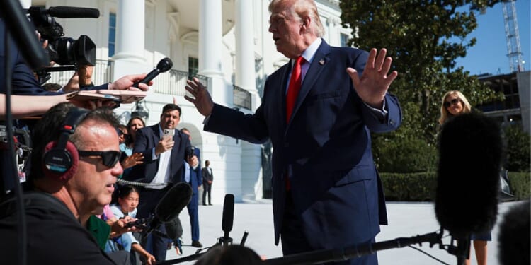 President Donald Trump stops to speak to members of the media Monday as he departs on the South Lawn of the White House in Washington, D.C.