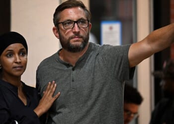 U.S. Rep. Ilhan Omar, a Minnesota Democrat, left, stands with her husband Tim Mynett at an August campaign rally in Milwaukee, Wisconsin.