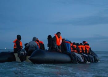 Migrants sit aboard a dinghy as they prepare to sail into the English Channel on Sept. 21, 2026, in Gravelines, France.