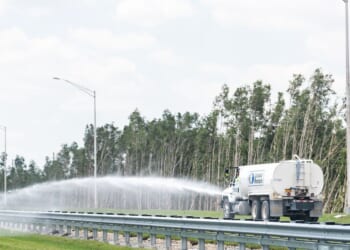 A truck spraying water on a highway near Miami, Florida, on April 30, 2018.
