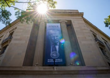 President Trump is displayed on a banner hanging between pillars at the Department of Justice headquarters in Washington, D.C. on May 18, 2026.